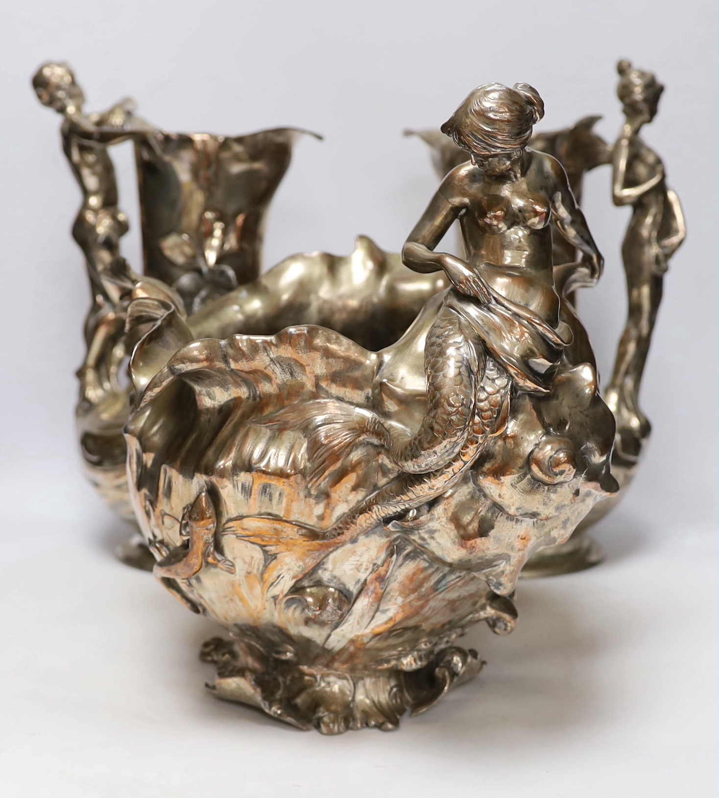 A pair of WMF Art Nouveau electroplated figural jugs and a similar mermaid jardiniere, unmarked, largest 35cm high